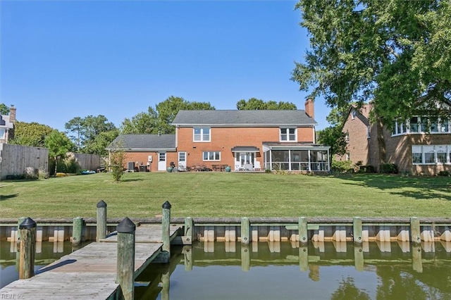 dock area with a water view and a yard