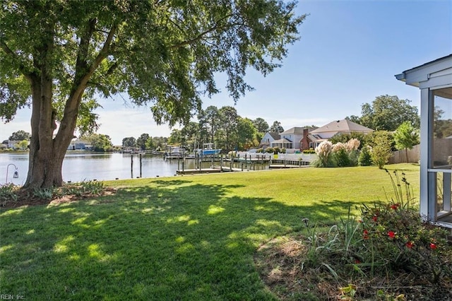 view of yard featuring a water view and a dock