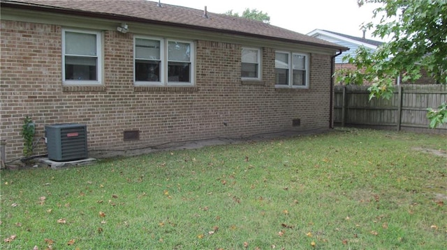 view of property exterior with a lawn and cooling unit