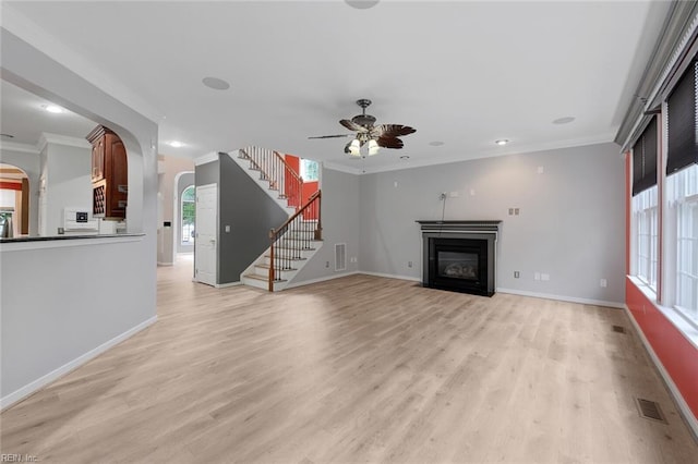 unfurnished living room with light wood-type flooring, crown molding, and ceiling fan