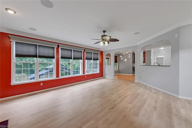 unfurnished living room featuring ceiling fan, light hardwood / wood-style floors, and ornamental molding