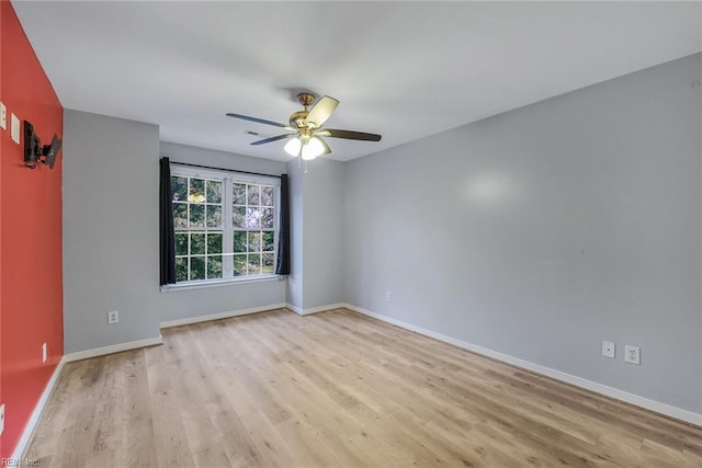 unfurnished room with ceiling fan and light hardwood / wood-style floors