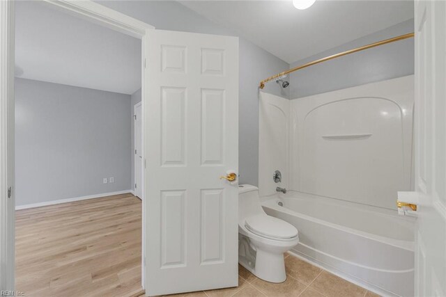 bathroom with wood-type flooring, toilet, and shower / bath combination