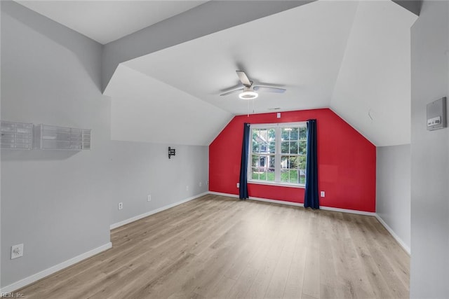 bonus room with light wood-type flooring, lofted ceiling, and ceiling fan