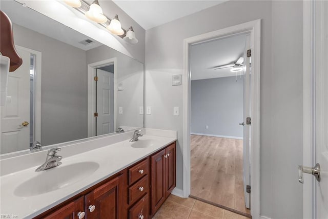 bathroom featuring wood-type flooring, ceiling fan, and vanity