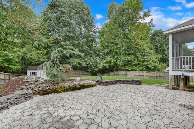 view of patio / terrace with a storage shed and a sunroom