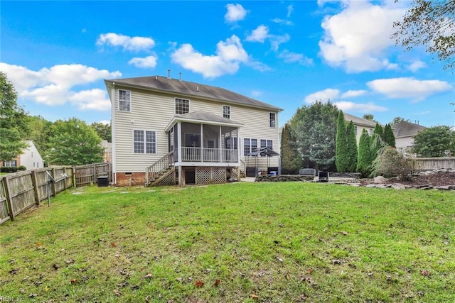 back of property featuring a lawn and a sunroom