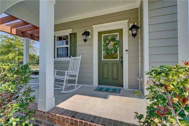 view of exterior entry featuring a porch