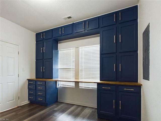 kitchen featuring blue cabinetry, electric panel, and dark hardwood / wood-style floors