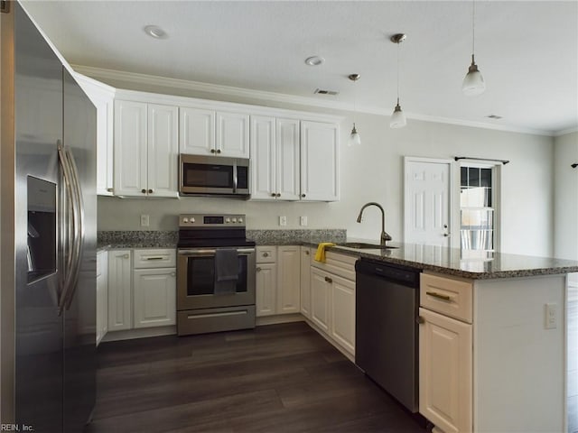 kitchen with appliances with stainless steel finishes, white cabinets, kitchen peninsula, dark hardwood / wood-style flooring, and decorative light fixtures