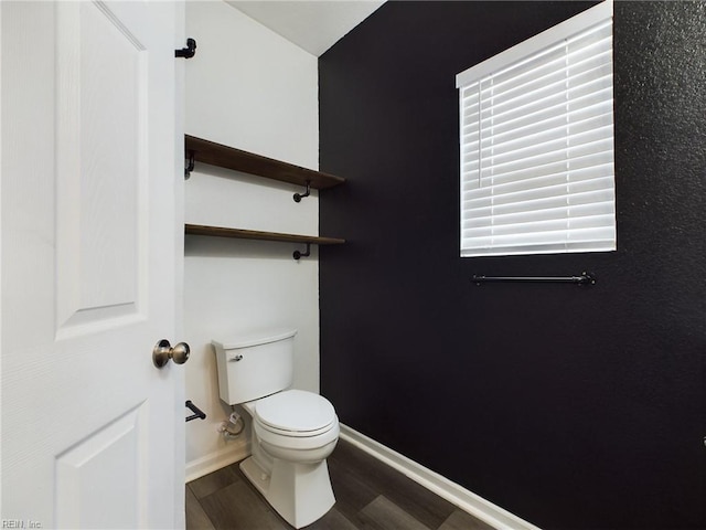 bathroom featuring wood-type flooring and toilet