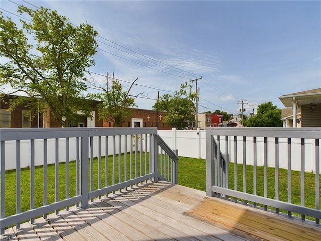 wooden terrace with a lawn