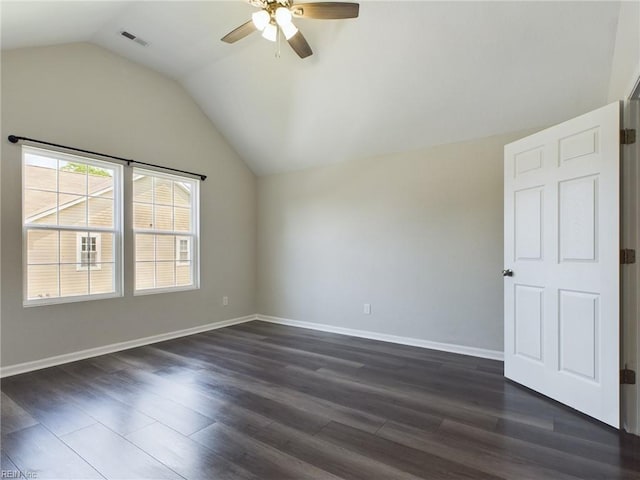 unfurnished room with vaulted ceiling, ceiling fan, and dark wood-type flooring