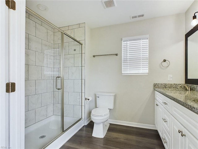 bathroom with walk in shower, vanity, hardwood / wood-style floors, and toilet