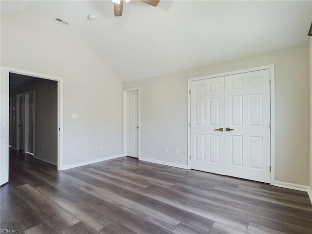 unfurnished bedroom featuring ceiling fan, lofted ceiling, dark hardwood / wood-style floors, and a closet