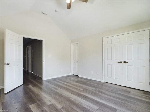 unfurnished bedroom with a closet, lofted ceiling, ceiling fan, and hardwood / wood-style floors