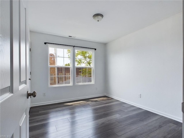 empty room featuring dark hardwood / wood-style flooring