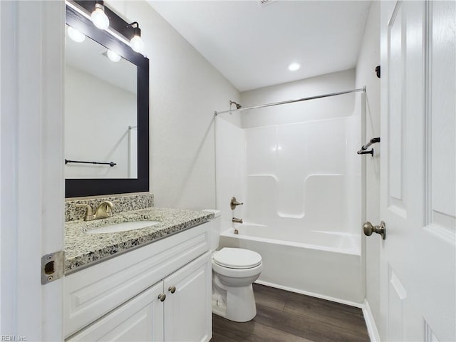 full bathroom with wood-type flooring, bathing tub / shower combination, vanity, and toilet