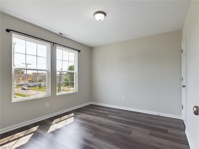 spare room featuring dark hardwood / wood-style flooring