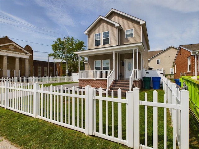 view of front of property featuring a front yard and covered porch