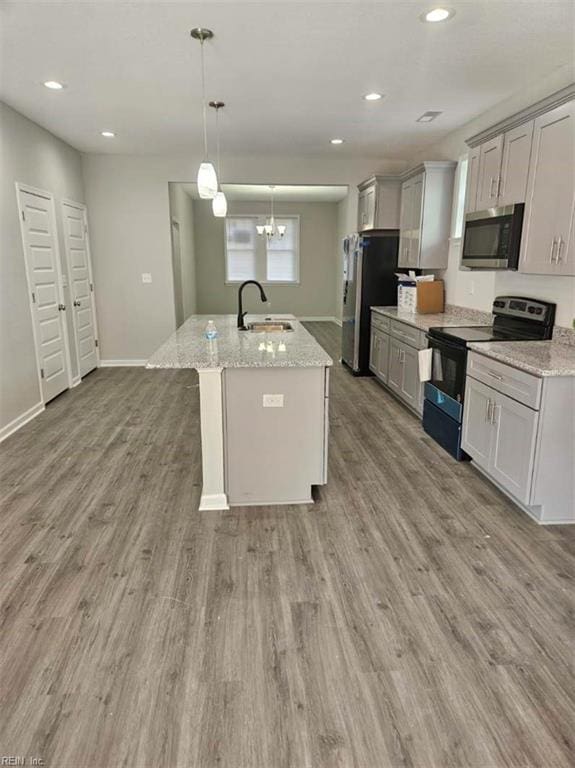 kitchen with gray cabinets, stainless steel appliances, hanging light fixtures, and sink