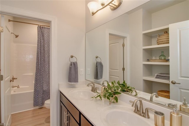 full bathroom with vanity, toilet, built in features, shower / bath combo with shower curtain, and hardwood / wood-style floors