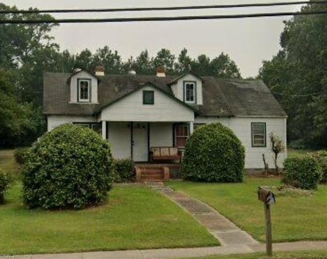 view of front of house with a front yard and a porch