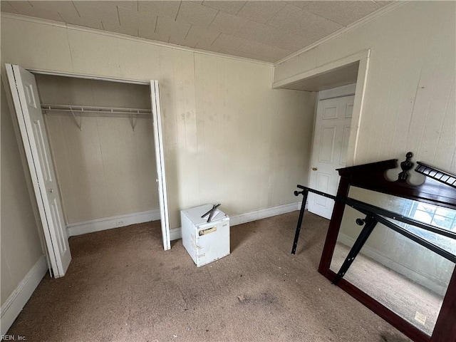 bedroom with ornamental molding, a closet, and carpet flooring