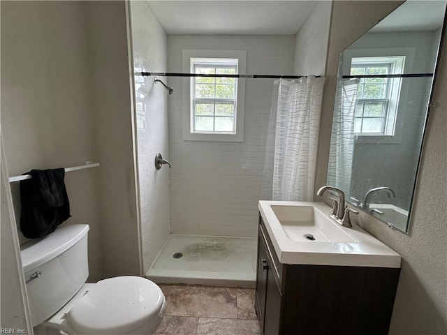 bathroom featuring walk in shower, vanity, and toilet