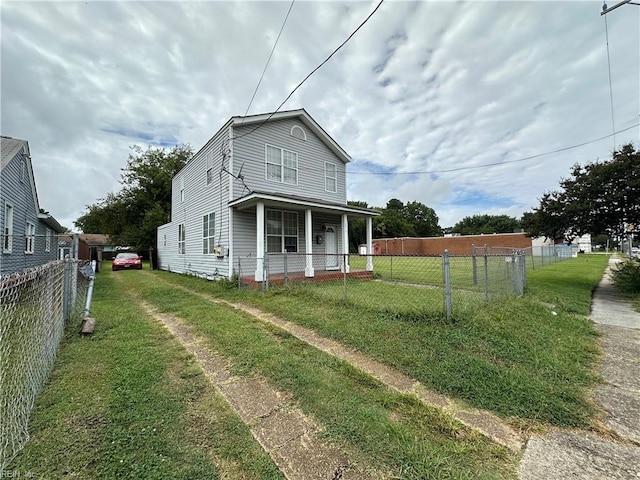 view of front of house featuring a front lawn and covered porch