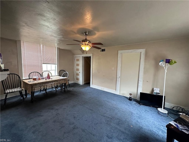 dining area with ceiling fan and a textured ceiling