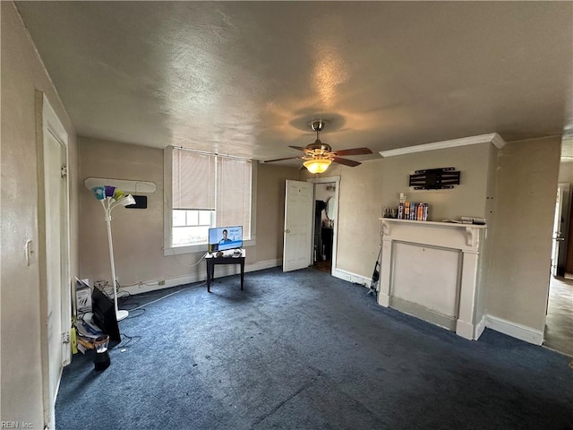 interior space featuring dark carpet, a textured ceiling, and ceiling fan