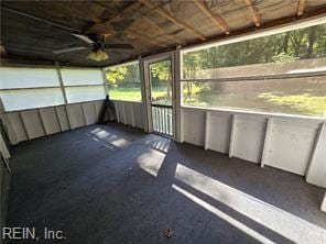 unfurnished sunroom with ceiling fan