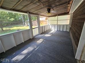 unfurnished sunroom featuring ceiling fan