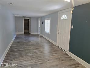 entrance foyer with a healthy amount of sunlight and dark hardwood / wood-style floors