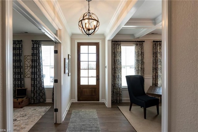 entrance foyer featuring ornamental molding, beam ceiling, dark wood-type flooring, and an inviting chandelier