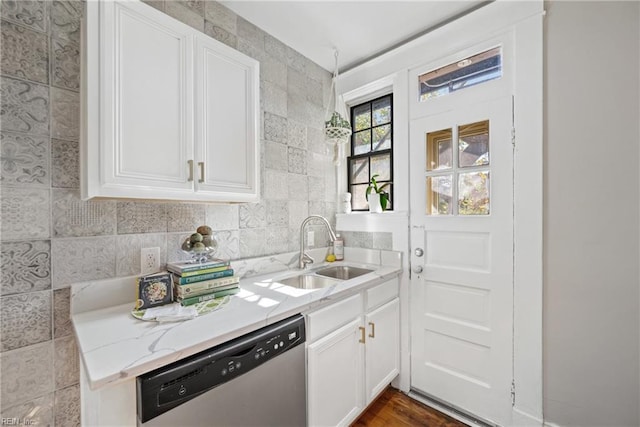 kitchen with white cabinetry, sink, light stone countertops, hardwood / wood-style floors, and dishwasher