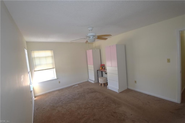 unfurnished bedroom with carpet flooring, lofted ceiling, and ceiling fan