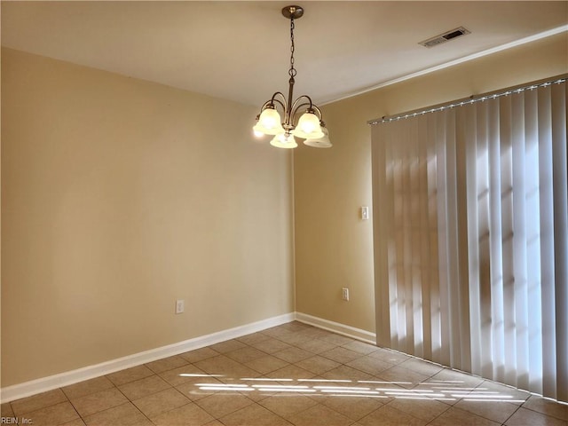 tiled spare room featuring an inviting chandelier