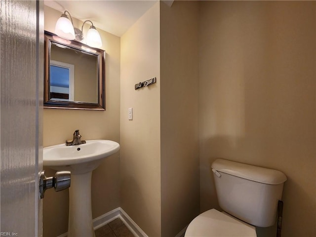 bathroom with toilet and tile patterned floors