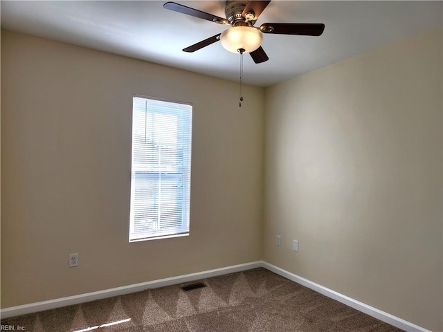 carpeted spare room featuring ceiling fan