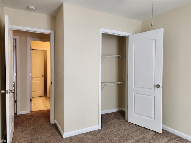 unfurnished bedroom featuring a closet and carpet flooring