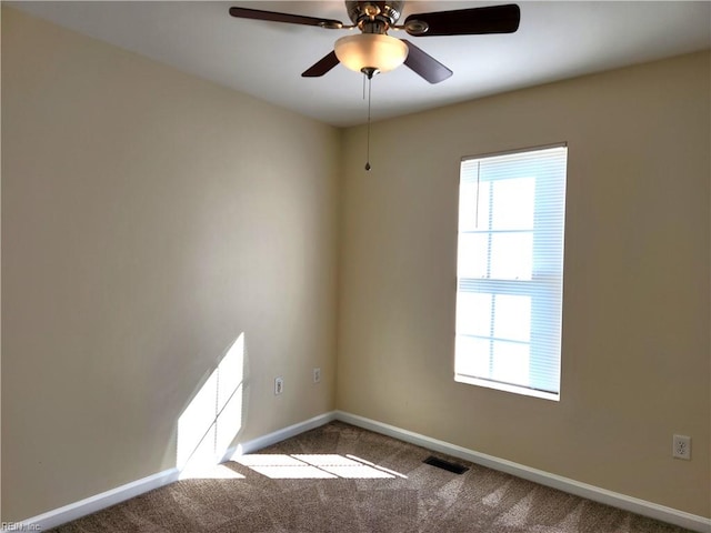 carpeted spare room with ceiling fan