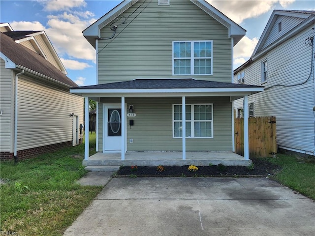 front of property featuring a porch and a front lawn