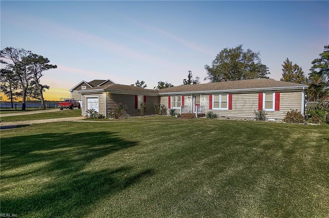 view of front of property featuring a garage and a yard