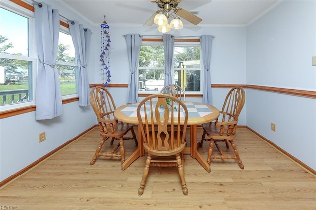 dining space featuring crown molding, plenty of natural light, and light hardwood / wood-style flooring