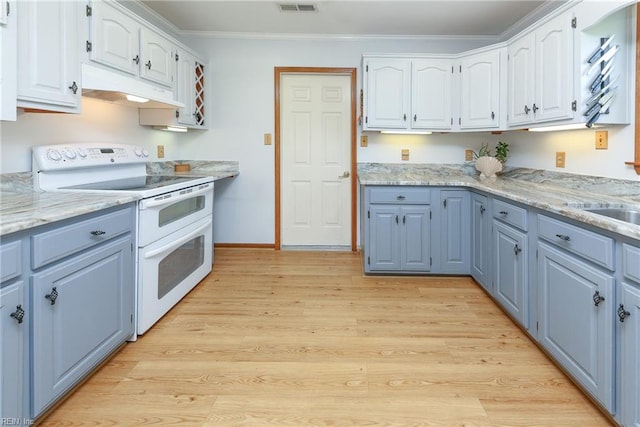 kitchen with light hardwood / wood-style floors, white range with electric cooktop, light stone countertops, ornamental molding, and white cabinetry