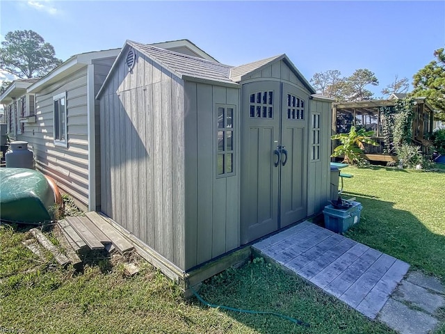 view of outbuilding with a lawn