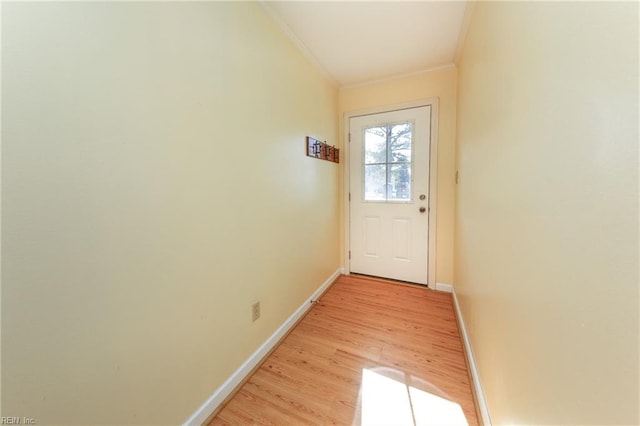 doorway to outside featuring light hardwood / wood-style floors and crown molding