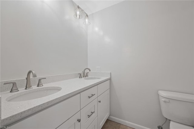 bathroom featuring tile patterned floors, vanity, and toilet